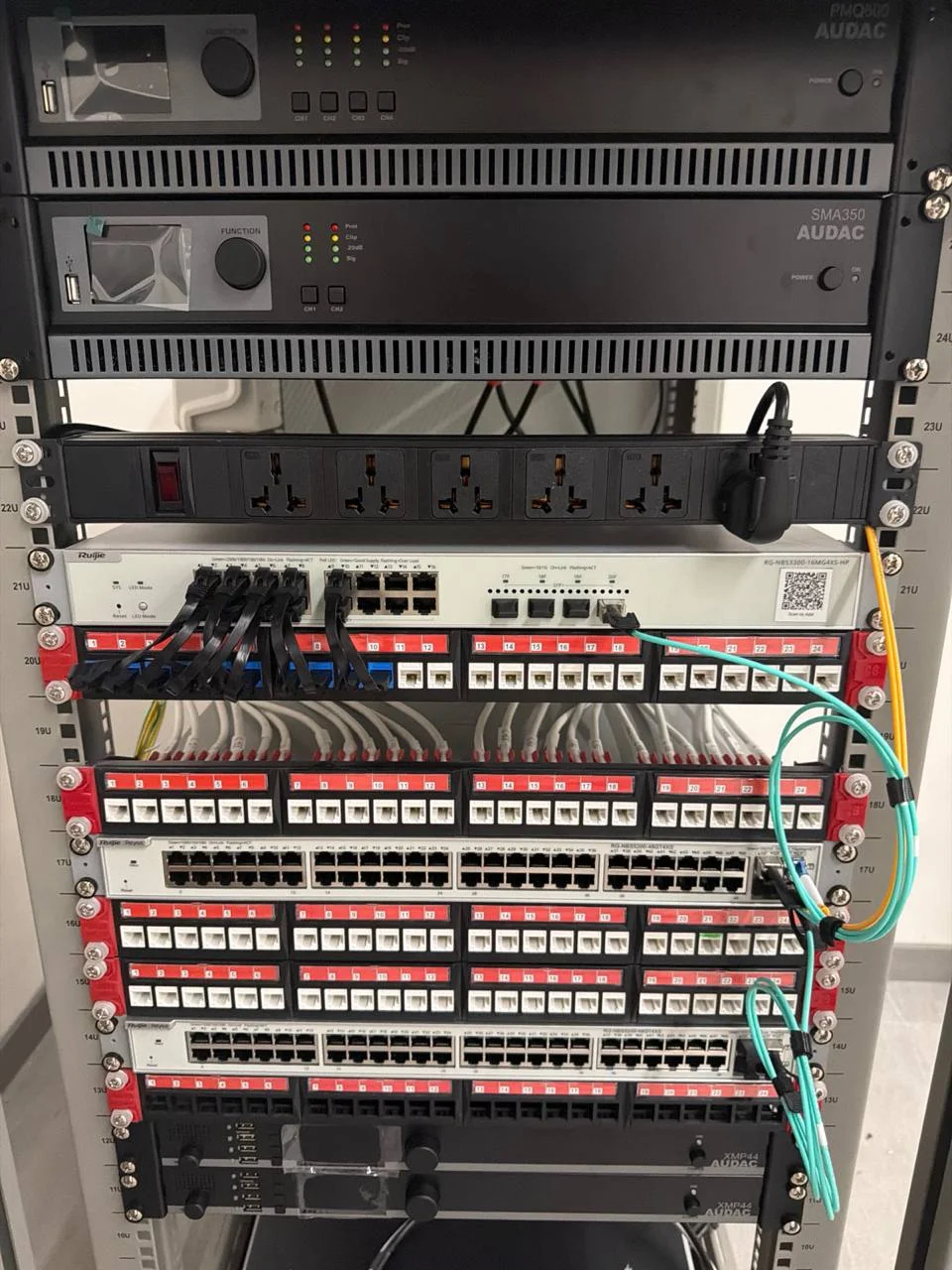 LUDUS Sports Complex server rack — Ruijie switch, patch panels, AUDAC SMA350 and PMQ800 amplifiers